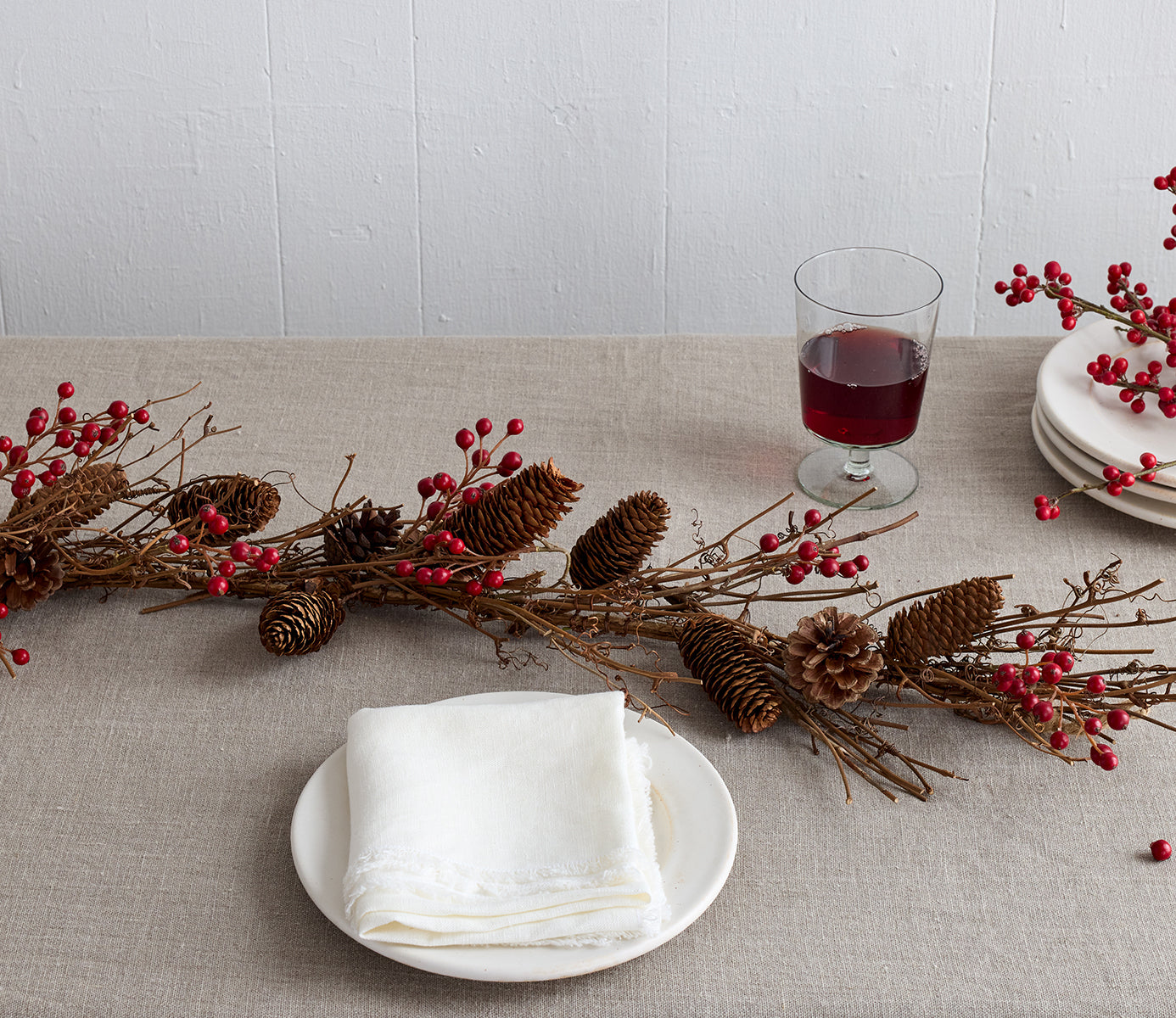 Faux red ilex berry garlands for winter mantel banister or holiday table styling
